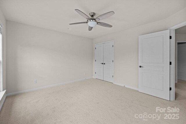 10508 Kristens Mare Dr, Charlotte, NC 28277 - unfurnished bedroom with light colored carpet, baseboards, a closet, and ceiling fan