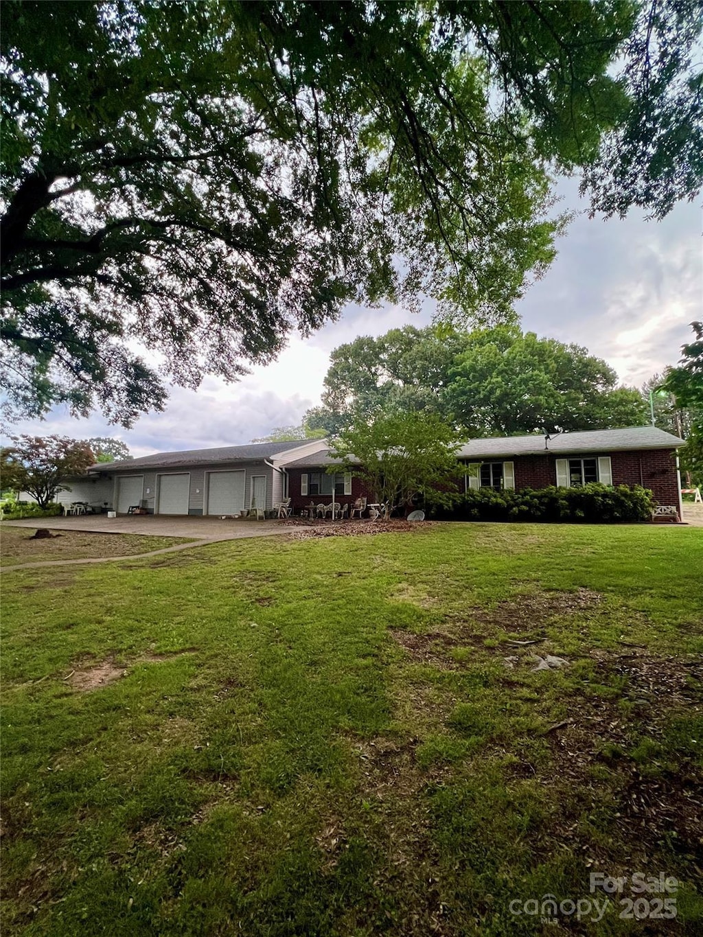 4002 Hickory Blvd, Granite Falls, NC 28630 - view of green lawn with an attached garage and driveway