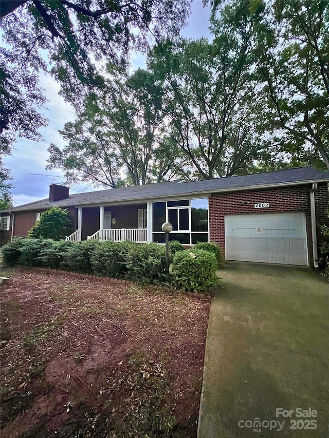 4002 Hickory Blvd, Granite Falls, NC 28630 - ranch-style house featuring brick siding, a garage, concrete driveway, and a porch