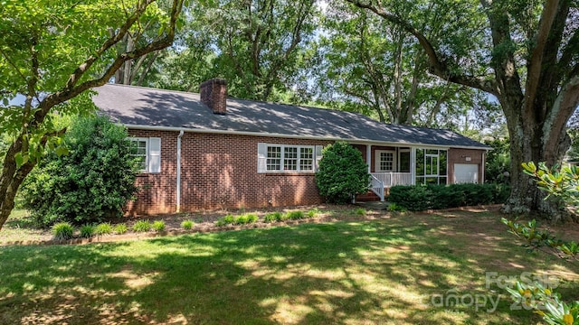 4002 Hickory Blvd, Granite Falls, NC 28630 - back of house with a chimney, a yard, brick siding, and a garage