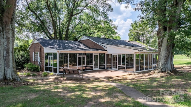 4002 Hickory Blvd, Granite Falls, NC 28630 - rear view of house with a sunroom, a patio, and a shingled roof