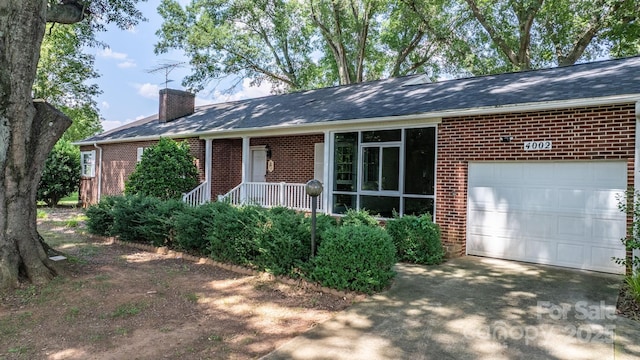 4002 Hickory Blvd, Granite Falls, NC 28630 - ranch-style house with brick siding, concrete driveway, a chimney, and a garage