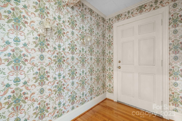 4002 Hickory Blvd, Granite Falls, NC 28630 - spare room featuring crown molding, wallpapered walls, and light wood-style flooring