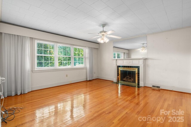 4002 Hickory Blvd, Granite Falls, NC 28630 - unfurnished living room featuring ceiling fan, a fireplace, and wood finished floors