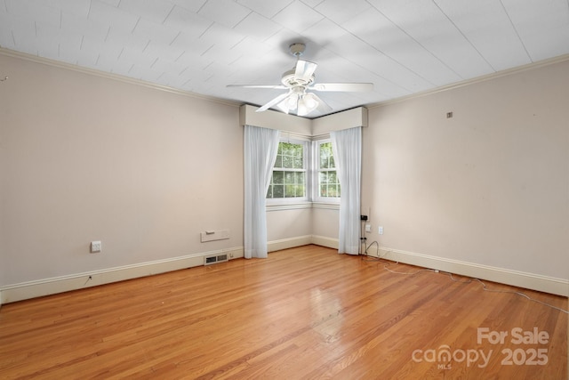 4002 Hickory Blvd, Granite Falls, NC 28630 - spare room featuring ornamental molding, a ceiling fan, and light wood finished floors