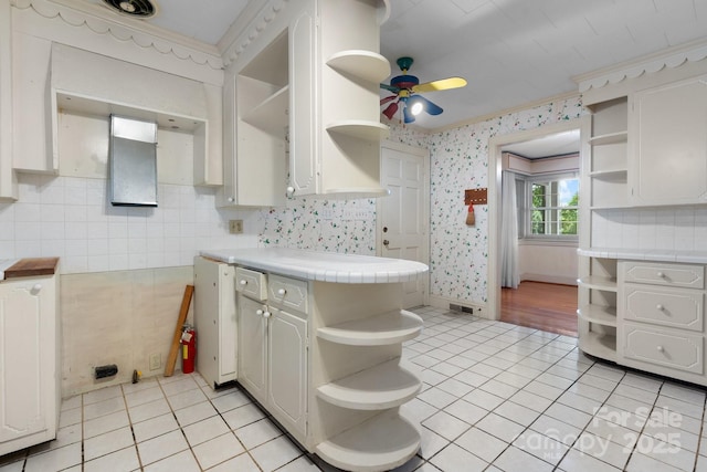 4002 Hickory Blvd, Granite Falls, NC 28630 - kitchen with open shelves, tile countertops, light tile patterned floors, a ceiling fan, and wallpapered walls
