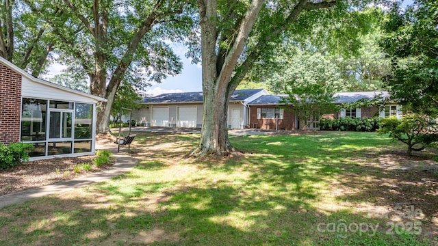 4002 Hickory Blvd, Granite Falls, NC 28630 - view of green lawn featuring a sunroom and a garage