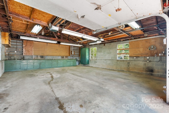 4002 Hickory Blvd, Granite Falls, NC 28630 - garage featuring concrete block wall and a garage door opener