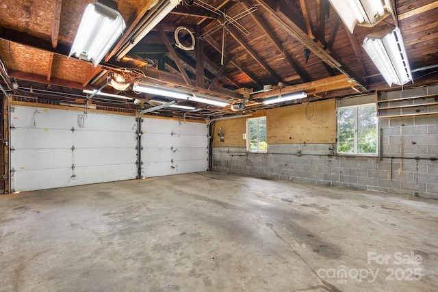 4002 Hickory Blvd, Granite Falls, NC 28630 - garage featuring a garage door opener and concrete block wall