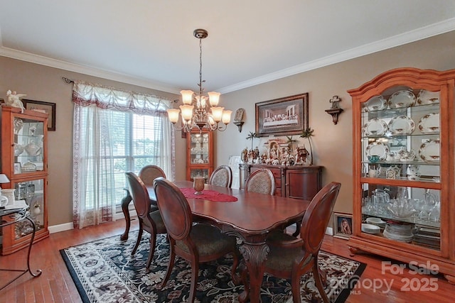 8409 Olde Stonegate Ln, Mint Hill, NC 28227 - dining area featuring a chandelier, light wood finished floors, crown molding, and baseboards