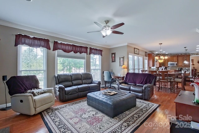 8409 Olde Stonegate Ln, Mint Hill, NC 28227 - living area with crown molding, a chandelier, a ceiling fan, and wood finished floors