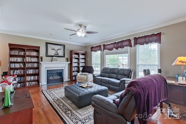 8409 Olde Stonegate Ln, Mint Hill, NC 28227 - living area with ceiling fan, a fireplace with flush hearth, wood finished floors, and ornamental molding