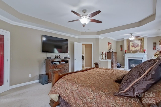 8409 Olde Stonegate Ln, Mint Hill, NC 28227 - bedroom with a raised ceiling, crown molding, a glass covered fireplace, carpet, and baseboards