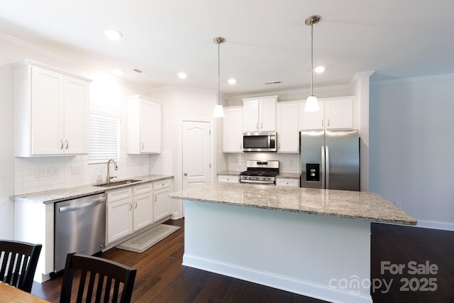 679 Cape Fear St, Fort Mill, SC 29715 - kitchen featuring appliances with stainless steel finishes, a center island, white cabinetry, ornamental molding, and recessed lighting