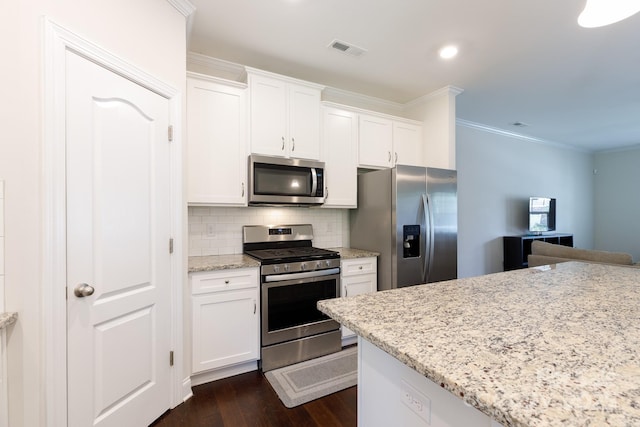 679 Cape Fear St, Fort Mill, SC 29715 - kitchen with appliances with stainless steel finishes, crown molding, white cabinetry, decorative backsplash, and dark wood finished floors