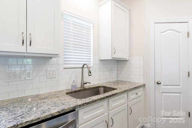 679 Cape Fear St, Fort Mill, SC 29715 - kitchen featuring white cabinets, decorative backsplash, stainless steel dishwasher, and light stone countertops
