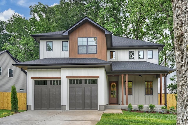 1834 Arnold Dr, Charlotte, NC 28205 - view of front of house featuring roof with shingles, a porch, concrete driveway, and an attached garage