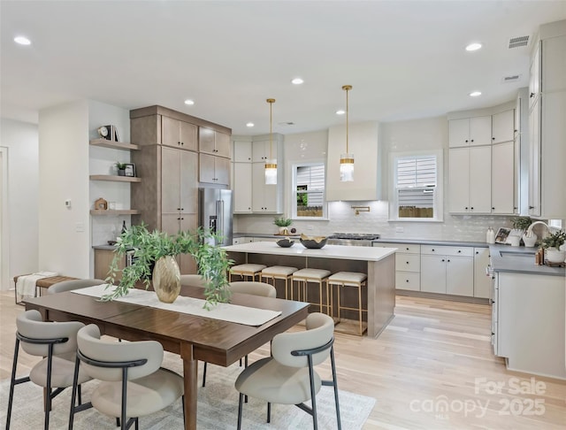 1834 Arnold Dr, Charlotte, NC 28205 - kitchen with a sink, high quality fridge, light wood-style flooring, backsplash, and a center island