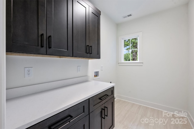 1834 Arnold Dr, Charlotte, NC 28205 - laundry room featuring cabinet space, washer hookup, baseboards, and light wood finished floors