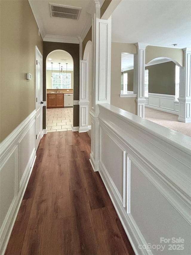 12904 Windy Lea Ln, Huntersville, NC 28078 - hall featuring arched walkways, a decorative wall, a sink, ornamental molding, and dark wood-style floors
