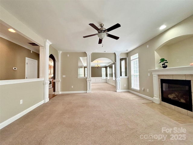 12904 Windy Lea Ln, Huntersville, NC 28078 - unfurnished living room featuring a tile fireplace, a ceiling fan, light carpet, recessed lighting, and decorative columns