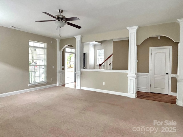 12904 Windy Lea Ln, Huntersville, NC 28078 - carpeted spare room featuring a ceiling fan, arched walkways, decorative columns, and baseboards