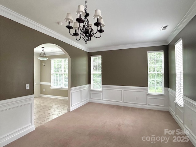 12904 Windy Lea Ln, Huntersville, NC 28078 - spare room with arched walkways, a chandelier, wainscoting, crown molding, and light colored carpet