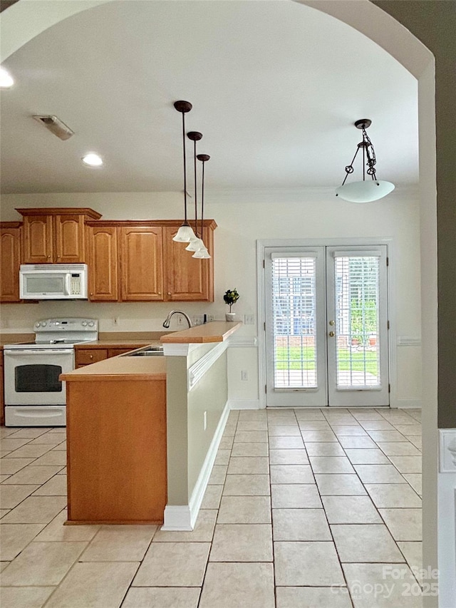 12904 Windy Lea Ln, Huntersville, NC 28078 - kitchen with white appliances, a sink, a peninsula, light tile patterned floors, and light countertops