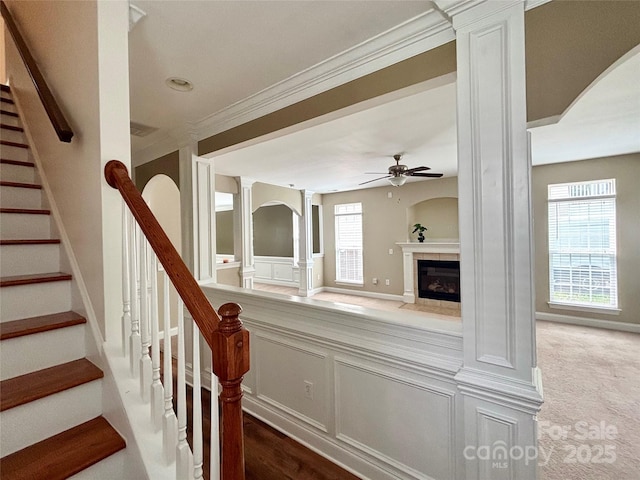 12904 Windy Lea Ln, Huntersville, NC 28078 - staircase with ornate columns, a ceiling fan, a tiled fireplace, healthy amount of natural light, and ornamental molding