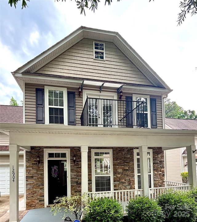 12904 Windy Lea Ln, Huntersville, NC 28078 - view of front of property with covered porch, a balcony, stone siding, and a garage