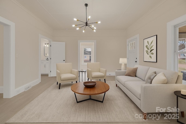 1003 S Ridge Ave, Kannapolis, NC 28083 - living room with a chandelier, light wood-style flooring, ornamental molding, and baseboards