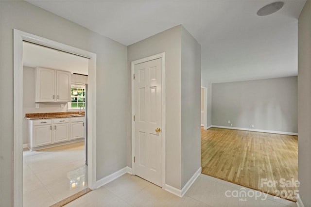 2301 Seth Thomas Rd, Charlotte, NC 28210 - hall featuring a sink, baseboards, and light wood-style flooring