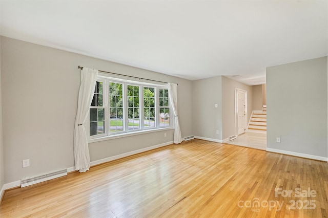 2301 Seth Thomas Rd, Charlotte, NC 28210 - empty room with stairway, light wood finished floors, baseboard heating, and baseboards