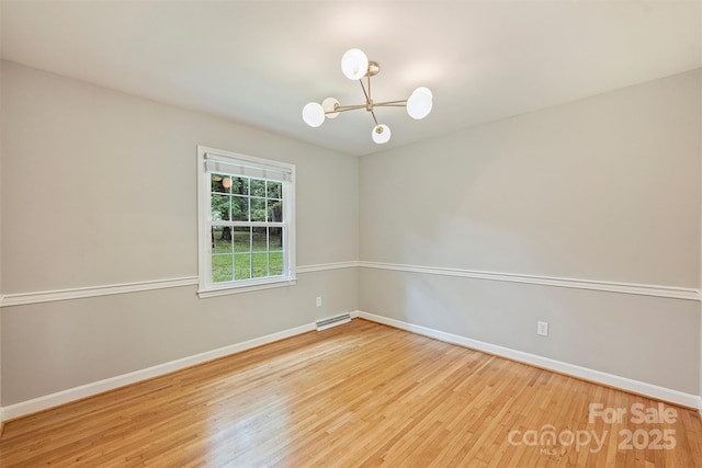 2301 Seth Thomas Rd, Charlotte, NC 28210 - empty room featuring a chandelier, wood finished floors, and baseboards