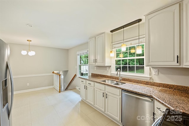 2301 Seth Thomas Rd, Charlotte, NC 28210 - kitchen featuring a sink, appliances with stainless steel finishes, pendant lighting, baseboards, and dark stone countertops