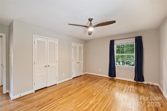 2301 Seth Thomas Rd, Charlotte, NC 28210 - unfurnished bedroom featuring multiple closets, light wood-style flooring, baseboards, and ceiling fan