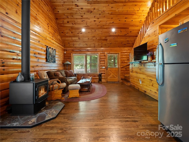 309 Doubleview Dr, Union Mills, NC 28167 - living area featuring wood finished floors, a wood stove, rustic walls, and high vaulted ceiling