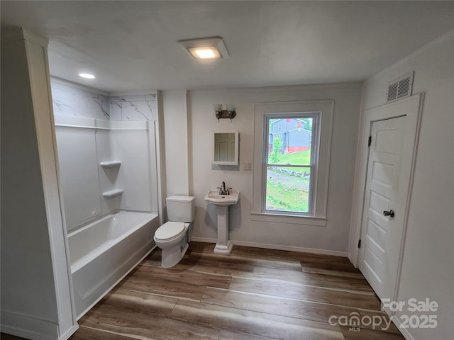 1434 N Hamilton St, High Point, NC 27262 - bathroom with toilet, wood finished floors, shower / tub combination, baseboards, and a sink