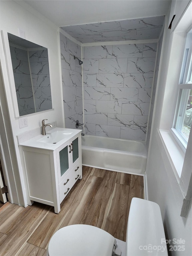 1434 N Hamilton St, High Point, NC 27262 - bathroom with toilet, vanity, bathtub / shower combination, and wood finished floors