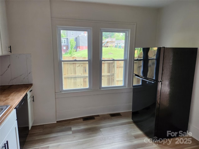 1434 N Hamilton St, High Point, NC 27262 - kitchen with black appliances, white cabinetry, and light wood-style floors