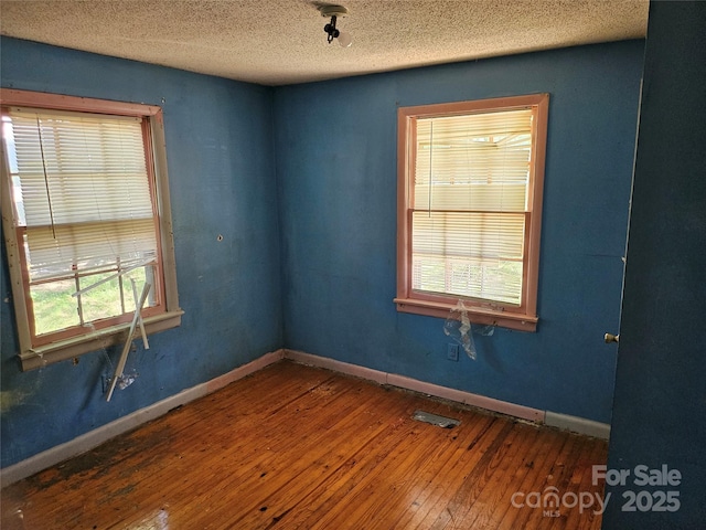 211 Putnam St, Shelby, NC 28152 - empty room featuring hardwood / wood-style floors and a textured ceiling