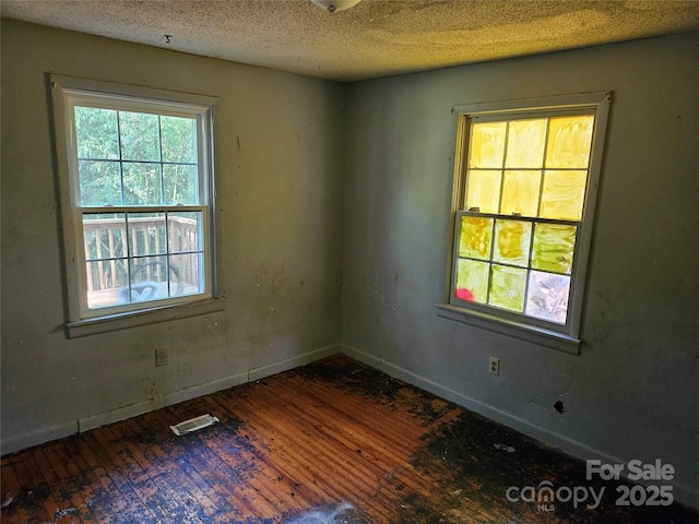 211 Putnam St, Shelby, NC 28152 - unfurnished room featuring hardwood / wood-style flooring and a textured ceiling
