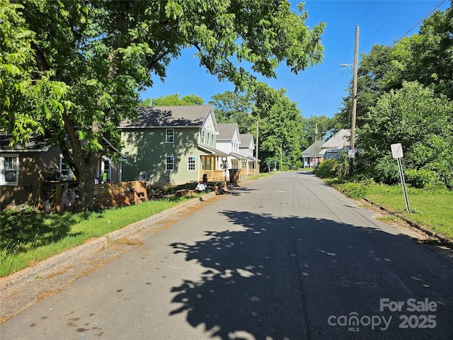211 Putnam St, Shelby, NC 28152 - view of asphalt street with street lighting, a residential view, and curbs
