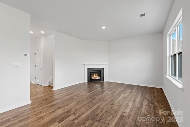 50 Lance Forest Rd, Fletcher, NC 28732 - unfurnished living room with dark wood-style floors, recessed lighting, a glass covered fireplace, and baseboards