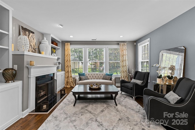 224 Wendover Heights Cir, Charlotte, NC 28211 - living area featuring dark wood-style floors, a fireplace with raised hearth, and recessed lighting