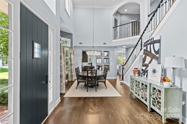 224 Wendover Heights Cir, Charlotte, NC 28211 - entrance foyer with a chandelier, wood finished floors, baseboards, a towering ceiling, and stairs