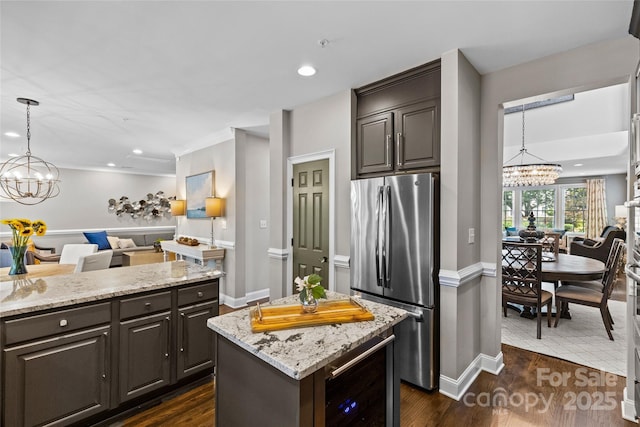 224 Wendover Heights Cir, Charlotte, NC 28211 - kitchen with freestanding refrigerator, a chandelier, beverage cooler, open floor plan, and light stone countertops