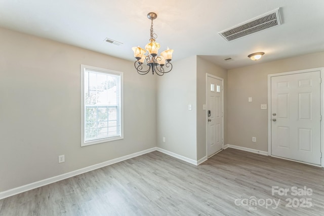 13413 Golden Apple Ct, Charlotte, NC 28215 - empty room featuring a chandelier, wood finished floors, and baseboards
