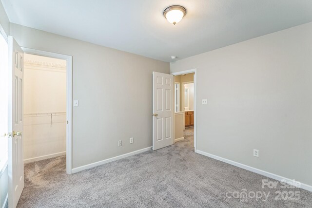 13413 Golden Apple Ct, Charlotte, NC 28215 - unfurnished bedroom featuring carpet, baseboards, and a spacious closet