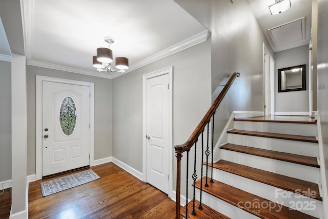 7050 Knightswood Dr, Charlotte, NC 28226 - entrance foyer featuring wood finished floors, ornamental molding, and a chandelier